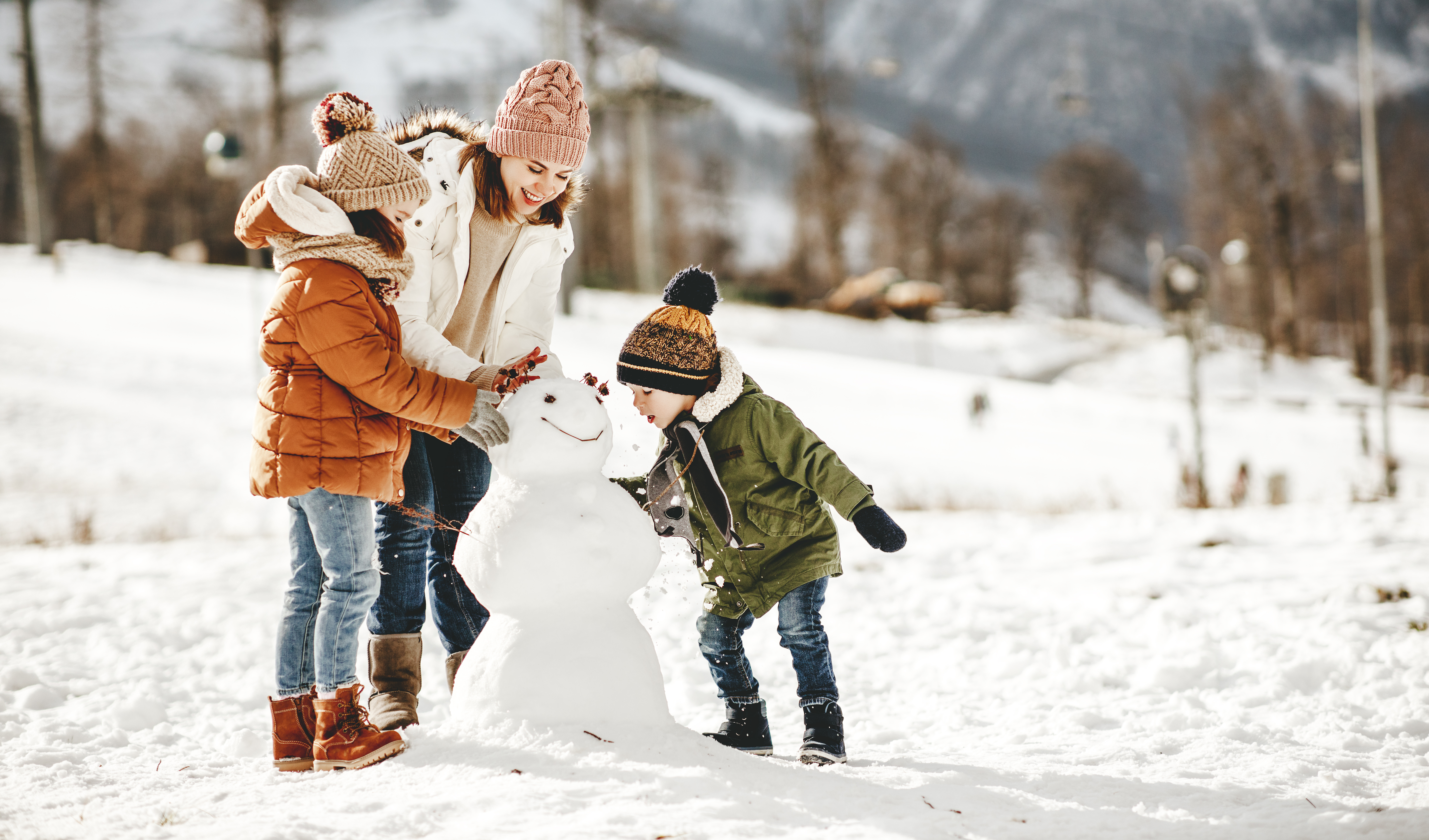 family building a snowman