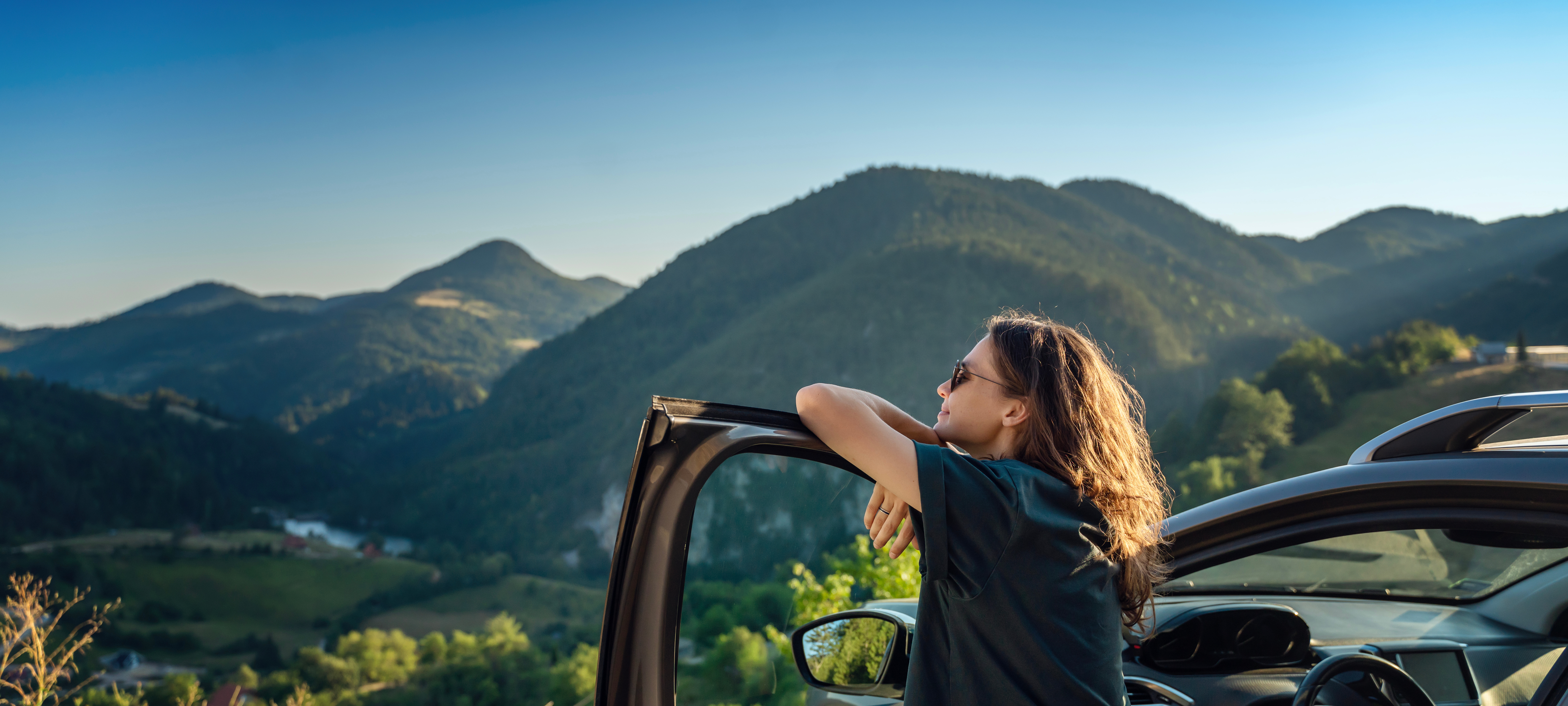 Woman staring at the mountains on vacation