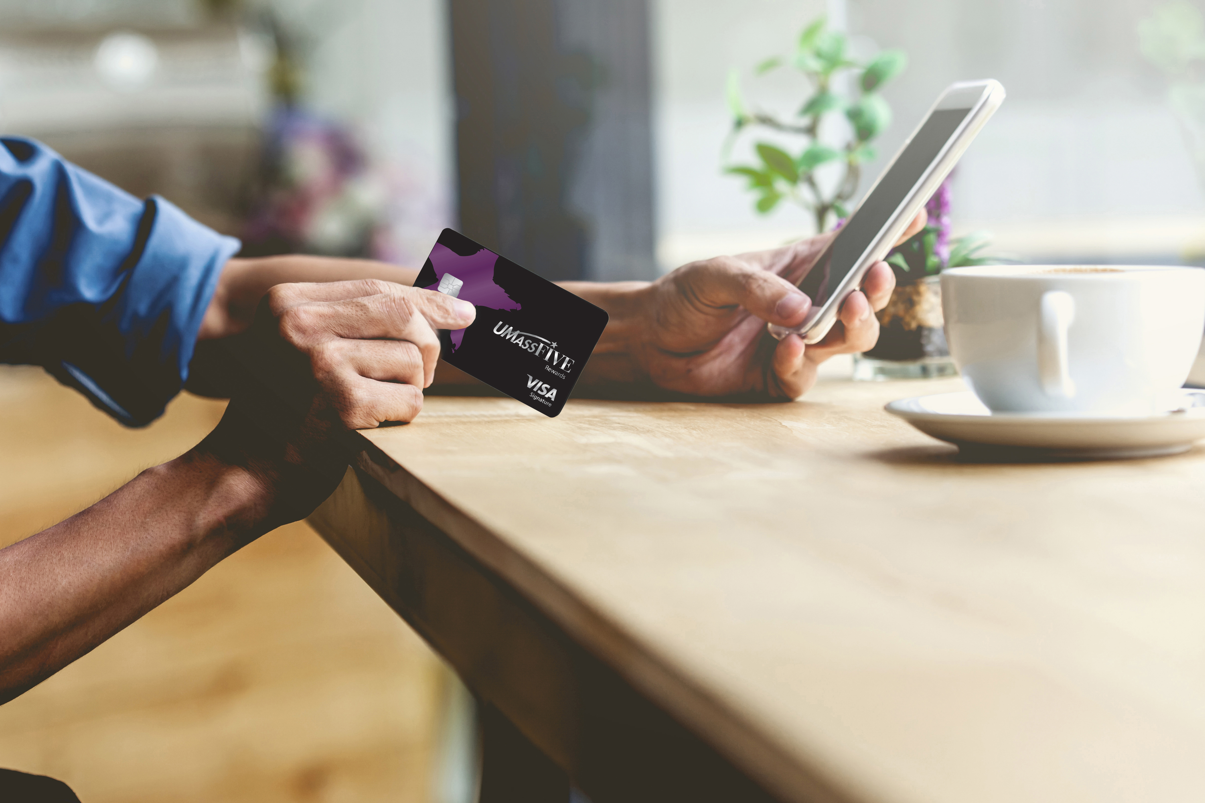 Man using rewards card at coffee shop