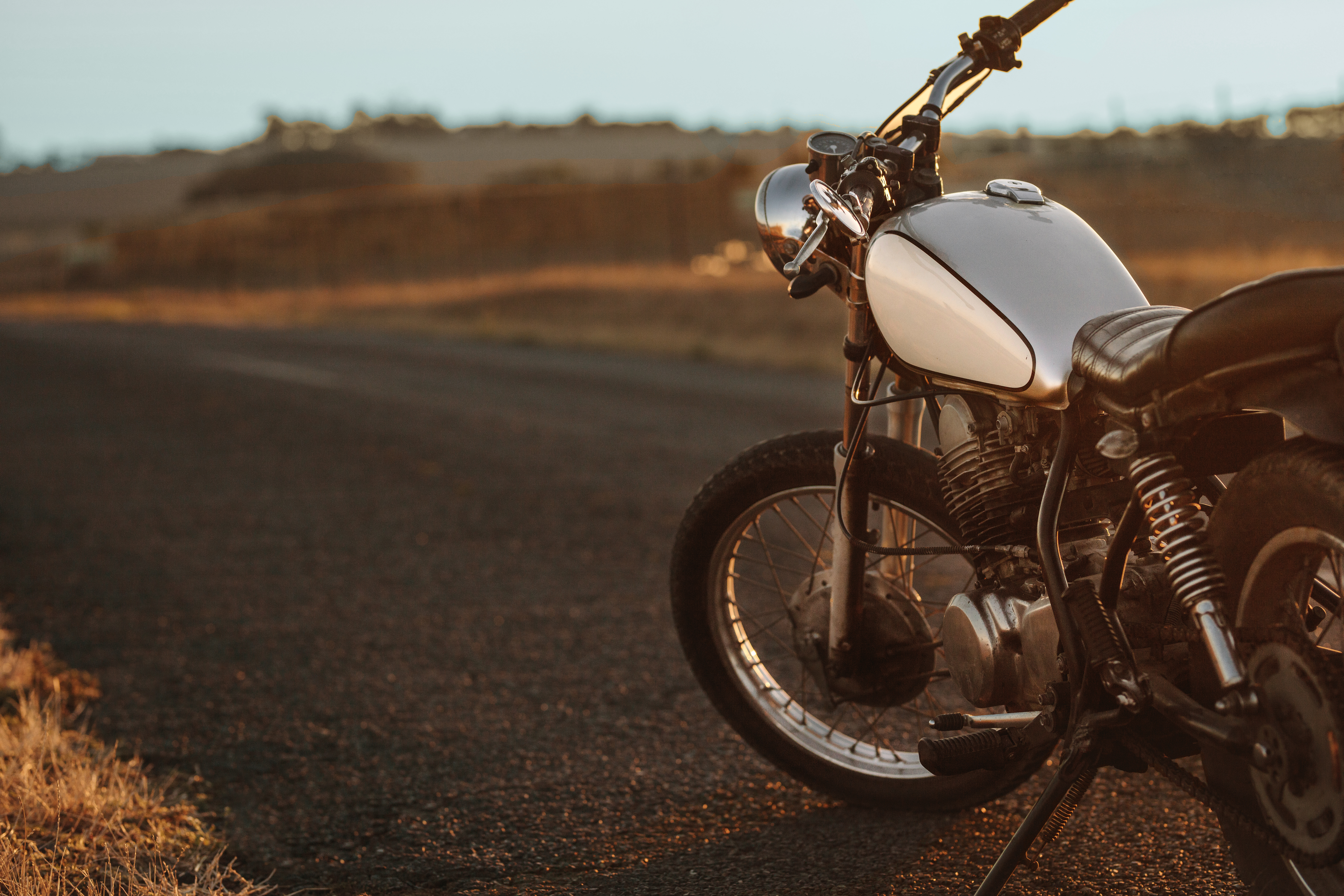 Motorcycle Parked on road at sunset