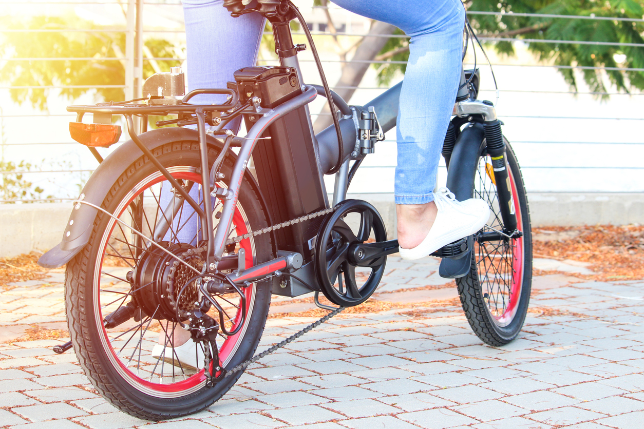 Person about to ride their electric bike on a sunny day