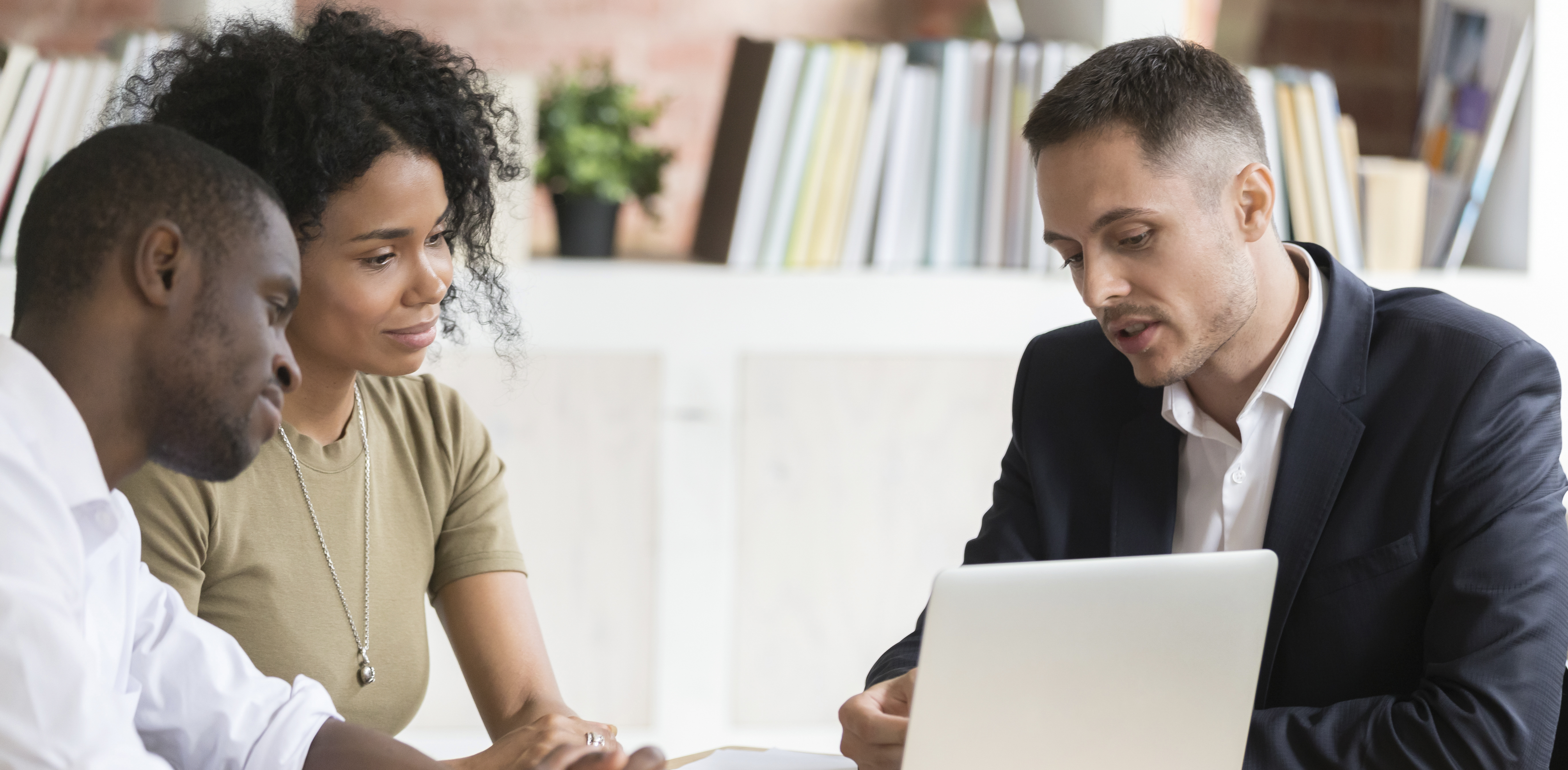 Financial Advisor reviews Life Insurance options with a young couple.