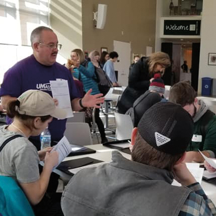 a UMassFive Volunteer reviews the success of the budgets students have made