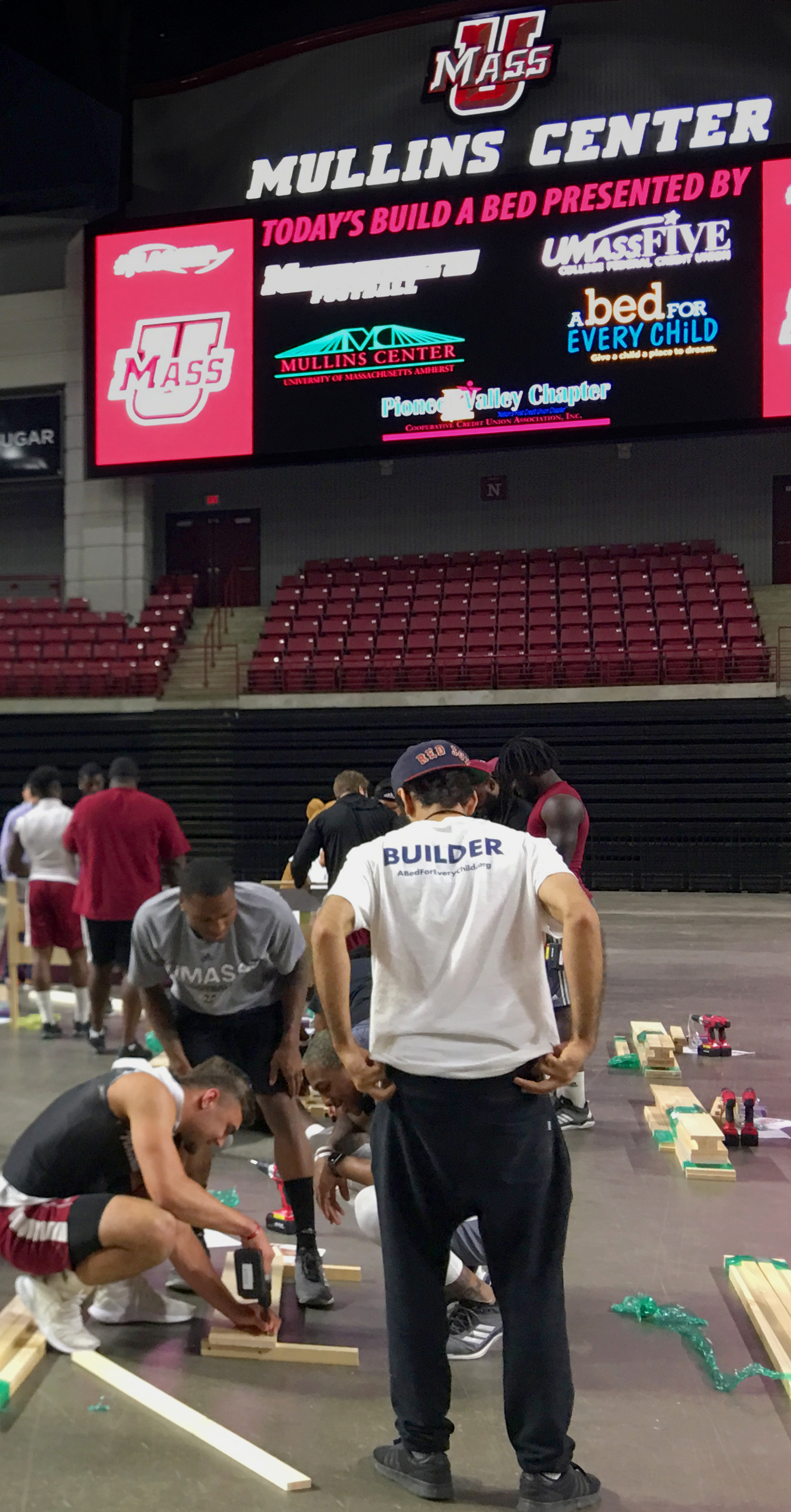 UMass Football Players building beds