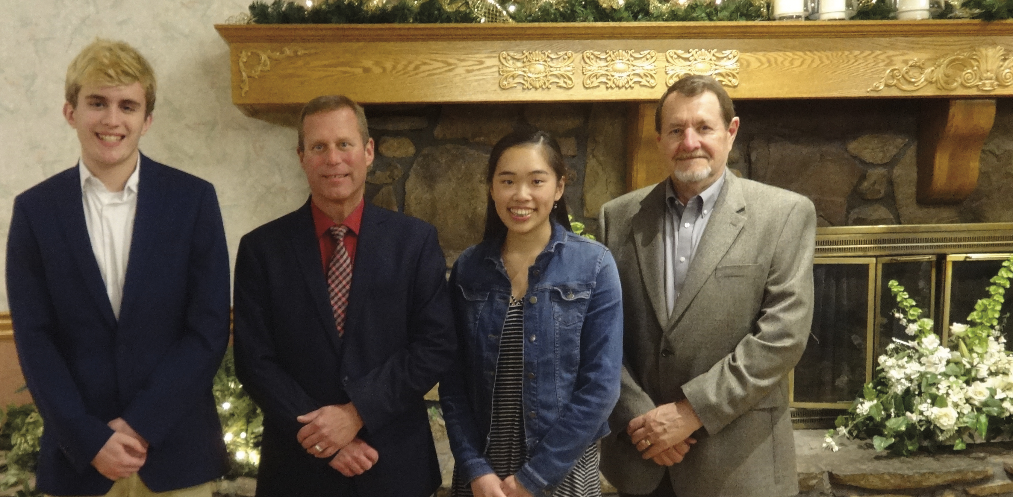 Kevin Johnson and Sabrina Sam pose with Board Chair Robert Harrison and VP of Retail Jim Wage